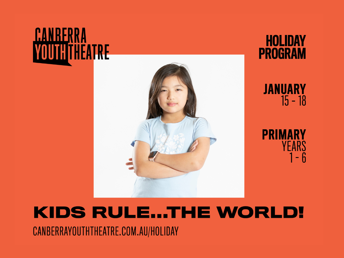 Young girl stand defiantly with her arms crossed in front of her.